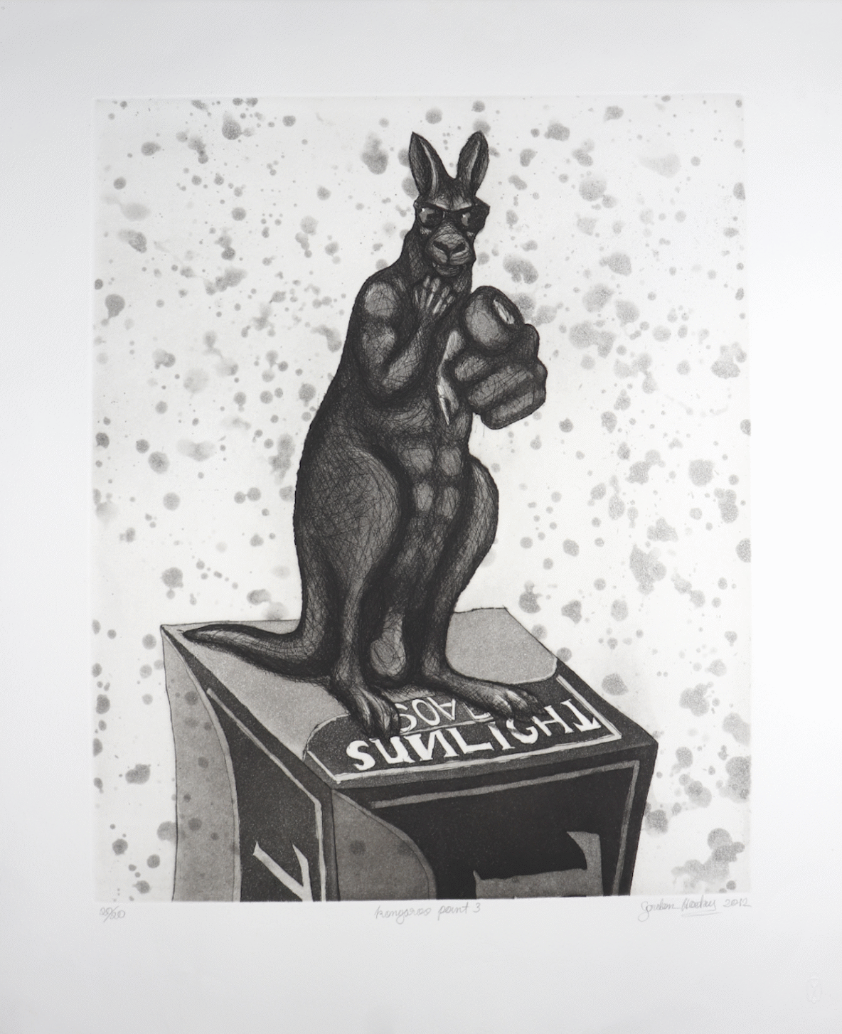 Dark, muscular kangaroo statue wearing sunglasses stands on a display box, pointing directly at the viewer against a speckled background.