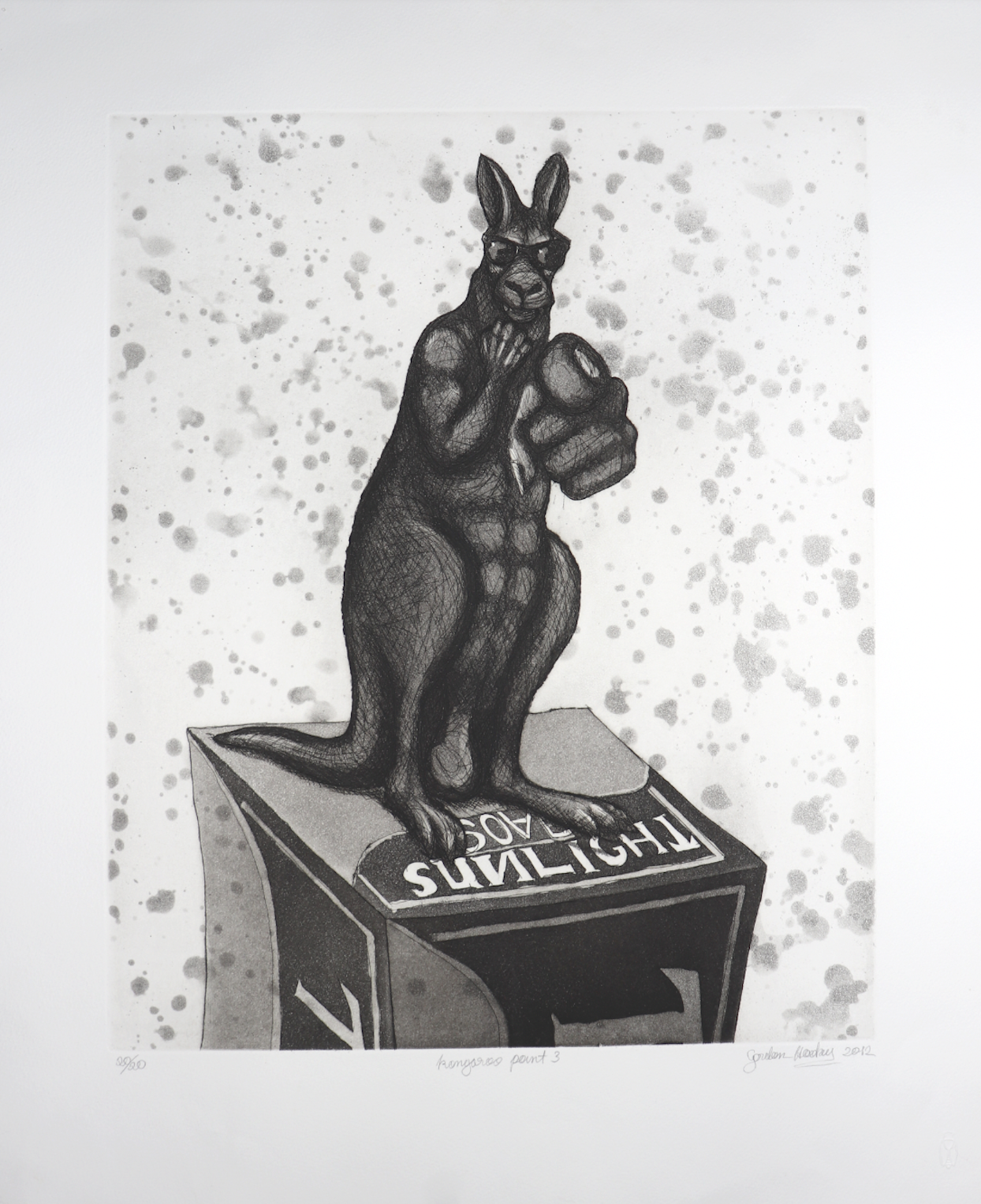 Dark, muscular kangaroo statue wearing sunglasses stands on a display box, pointing directly at the viewer against a speckled background.
