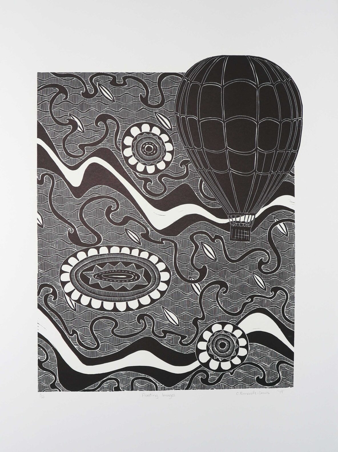 Black-and-white abstract print with a large hot-air balloon shape above swirling patterns and circular floral motifs.