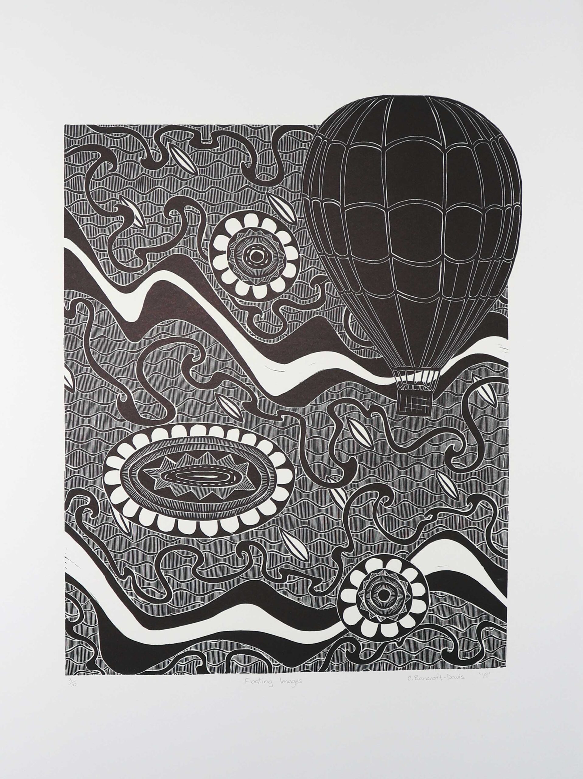 Black-and-white abstract print with a large hot-air balloon shape above swirling patterns and circular floral motifs.